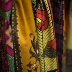 Close up shot on colorful African print dresses hanging on rack