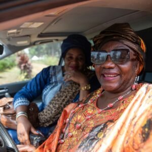 Two African women in the car take a selfie. Friendship between women concept